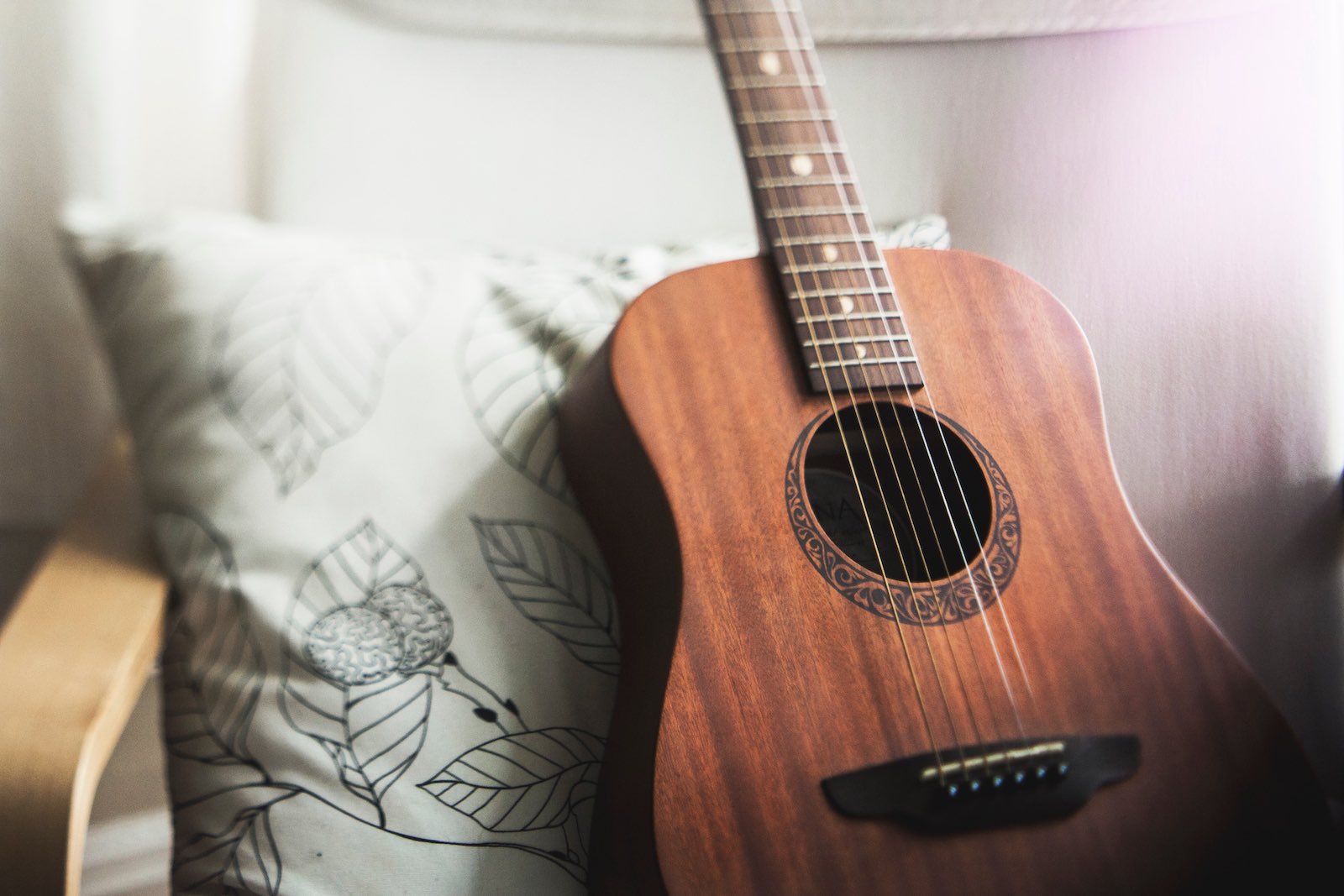 Guitar leaning on a pillow