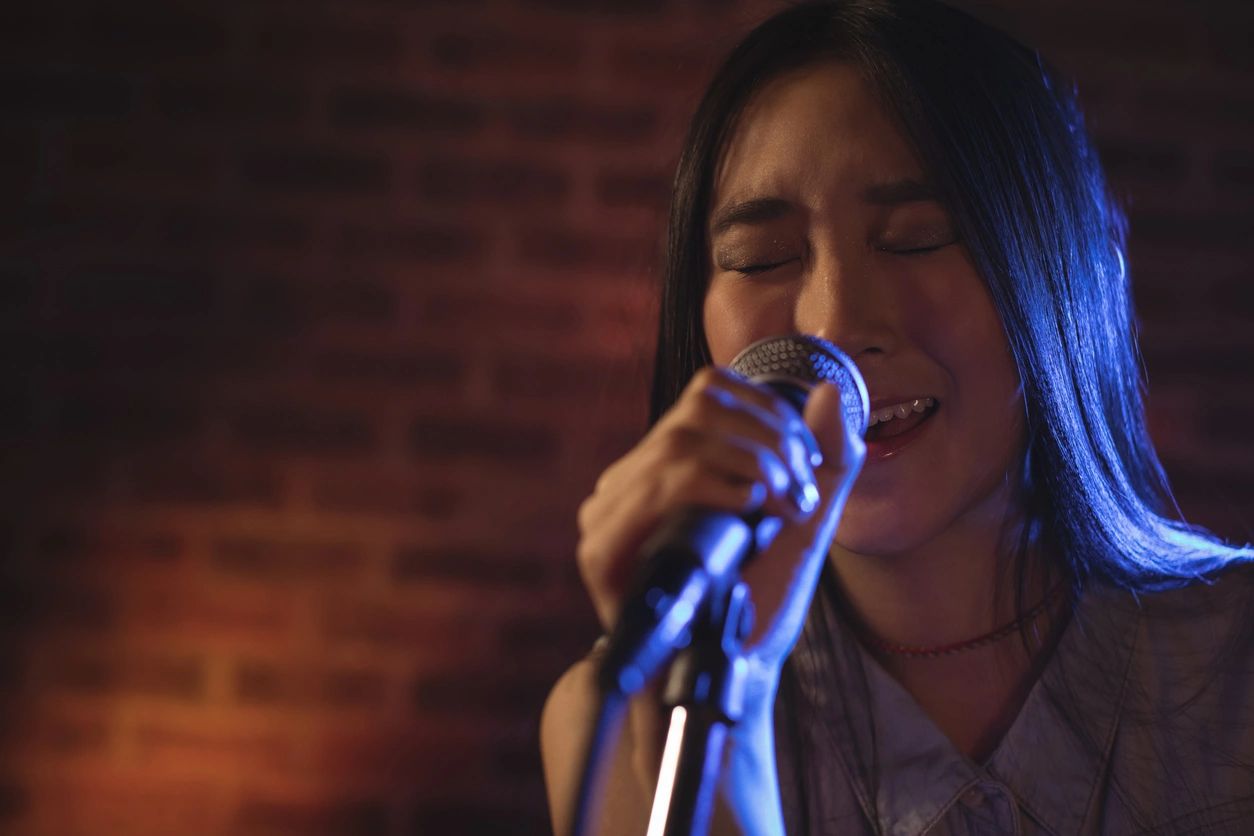 A vocalist singing into a microphone